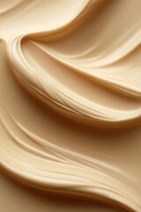 Poster - Luminous beige cream swirl close up showcasing smooth texture and elegant curves for skincare product background