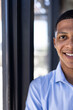 © Wavebreak Media - Smiling man in blue shirt standing by window at office, copy space