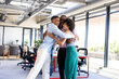 © Wavebreak Media - diverse colleagues embracing and celebrating success in modern office space