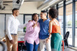 © Wavebreak Media - Diverse colleagues in office smiling and chatting during casual diverse team meeting