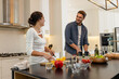 © Wavebreak Media - Couple preparing meal together in modern kitchen, smiling and enjoying conversation, at home