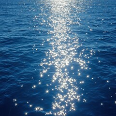 Poster - Sparkling sunlight reflection on deep blue ocean water creating a mesmerizing and tranquil scene seascape view from above