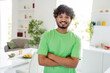 © deagreez - Smiling young man in bright kitchen during daytime, enjoying leisurely home environment with a healthy meal on the table.