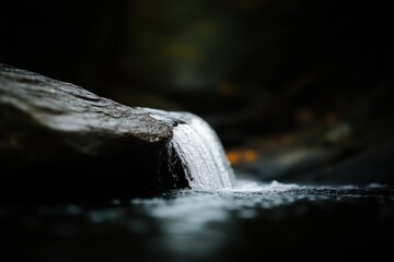 Poster - Dark and Serene Waterfall Cascading Over Rock in a Forest Stream