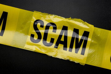 Fototapete - Close-up of yellow caution tape with the word 