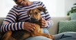 © CineLens24/peopleimages.com - Relax, dog and sofa with person in living room of home for love, loyalty and animal care. Support, trust and foster puppy with woman and pet in apartment for playful, comfort and domestic together