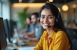 © Pete - Smiling Indian call center agent wearing headset works in customer support office. Happy woman consulting clients. Support specialist, customer service representative in workplace.