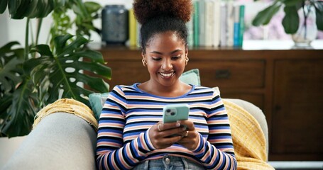 Leinwandbilder - Texting, online and woman with smartphone, calm and communication for chat in living room and smile. Comfortable, typing and black person with mobile in lounge, couch and girl on dating site in house
