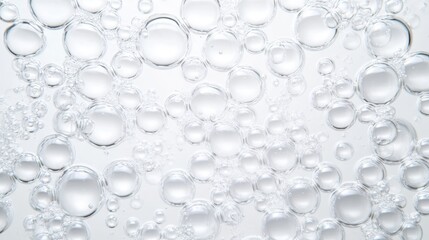 Poster - Transparent oxygen bubbles varying in size floating on water surface, forming abstract white background pattern with delicate underwater texture and visual depth