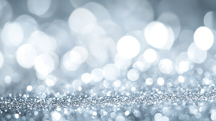 Poster - A shimmering surface of silver glitter with a soft bokeh background of blurred lights above it