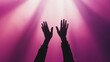 © JK_kyoto - Hands raised to light with vibrant purple background