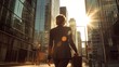 © katak - A business woman walking down a city street towards bright sunshine