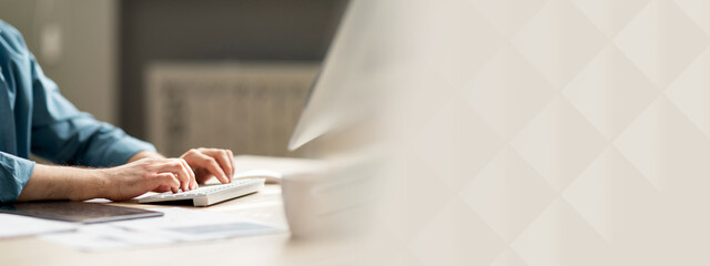 Poster - Young man sitting at desk and typing on computer keyboard, cropped shot of guy employee using pc in office, working online, businessman answering emails, side view, closeup