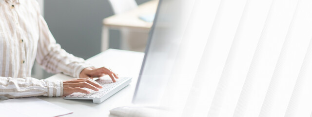 Poster - Unrecognizable woman employee working on computer at desk in office, cropped image of lady typing on keyboard, writing email or communicating online