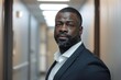 © CojanAI - Portrait of a confident black man in office hallway