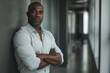 © CojanAI - Portrait of a confident black man in office hallway