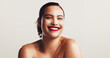 © KayExam/peopleimages.com - Portrait, shine and woman with skincare, cosmetics and wellness on white studio background. Face, person and model with glow, aesthetic or smile with dermatology, healthy skin or beauty with grooming