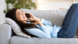© Prostock-studio - Positive Asian Girl Relaxing On Couch, Talking On Cellphone With Friends, Enjoying Weekend Relax, Side View