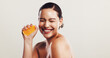 © KayExam/peopleimages.com - Happy woman, orange or squeeze with vitamin C for detox, skincare or nutrition on a white studio background. Female person, model or smile with natural organic fruit for healthy antioxidant on space