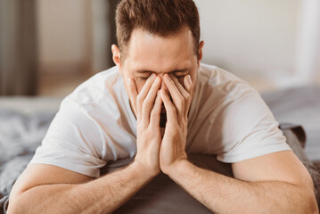 Aufkleber - Bad Sleep. Guy Rubbing Eyes Waking Up Sleepy In The Morning Lying On Stomach In Bed In Bedroom At Home. Tired Man Having Headache And Insomnia Problem. Sleeplessness Concept