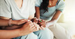 © peopleimages.com - Women, support and holding hands with discussion on sofa for care group or intervention at home. Closeup, female people or listening with friends on couch for confession, empathy or sympathy at house