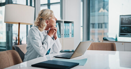 Poster - Doctor, healthcare and laptop with woman thinking in office of hospital for diagnosis, planning or research. Computer, medical and vision with mature professional practitioner at desk in clinic