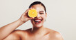 © KayExam/peopleimages.com - Happy woman, orange and citrus with vitamin c for skincare, detox or nutrition on a white studio background. Female person, model or smile with natural organic fruit for health or anti aging skin