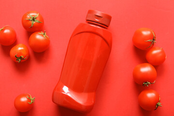 Wall Mural - bottle of ketchup and tomatoes on red background