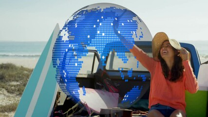 Poster - Woman in sun hat enjoying beach with digital globe animation over scene