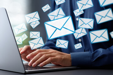 Leinwandbilder - Email marketing for business. Sending and receiving many emails. Businessman typing on laptop computer keyboard at desk in office.