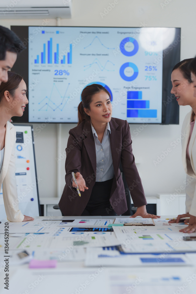 Business team analyzing financial data and discussing marketing ...