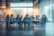 © ttonaorh - Blurred background of a business meeting in a modern office with people sitting at a table, a team working together having a discussion. View through a glass wall