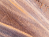 Aerial view of desert sand texture background. An abstract ground texture reveals natural patterns and tire track.