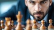 © maesarin - Determined Businessman Strategizing Chess Moves for Business Success and Triumph Over Challenges  Conceptual image representing leadership intelligence decision making
