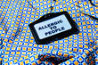 © VISTA by Westend61 - Name tag with text 'Allergic to People' on a colorful geometric shirt
