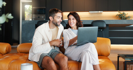 Poster - Home, discussion and couple on sofa, laptop and connection with comfort in lounge. Email, man and woman on couch, computer and conversation with entertainment, internet and relax with website info