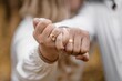 A guy puts a diamond engagement ring on his girlfriend's finger, close-up photo. An offer of a hand and a heart. Wedding ring