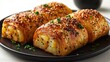 © FH Studio - pastry roll filo potato with sesame well baked, on black plate,