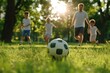 © Endin - Family playing soccer in grass outdoors