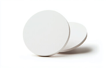 Poster - Two white circular objects stacked slightly overlapping on a bright white background studio shot
