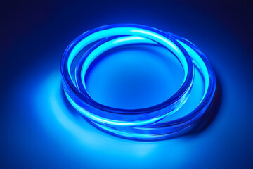 Poster - Illuminated blue rings intertwined on a dark surface casting a soft blue glow around the object