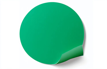 Poster - A green round sticker with a curled corner on a white background in a studio shot close up view