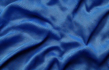 Poster - Close up shot of blue mesh fabric with folds and shadows creating a textured and patterned surface