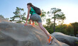 © bilanol - Young woman climbing alone on rocky mountain path. Female hiker enjoying difficult challenge on wilderness trail. Active way of life concept