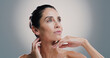 © Jess B/peopleimages.com - Skincare, thinking and woman with beauty, glow and idea for anti aging treatment. Mature model, natural cosmetics and facial dermatology for self care, wellness and health on gray studio background