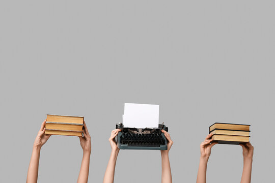 Women with vintage typewriter and books on color background