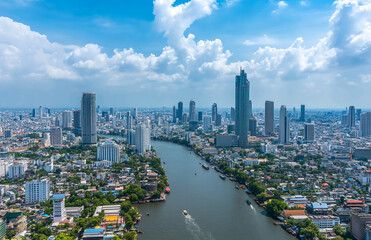 Poster - Aerial view of bangkok cityscape with chao phraya river flowing through the urban landscape under cloudy skies