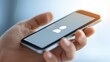 © Ndoomyim - Closeup of person holding apple phone, mobile technology and communication in the digital age