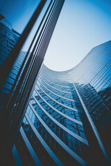 Poster - Striking Modern Architecture with Glass Facades Piercing the Sky in Cool Blue Tones