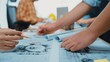 © InfiniteFlow - A dynamic workspace showcasing designers engaged in collaborative planning, drafting intricate technical drawings and blueprints. A creative and professional environment. SACTR